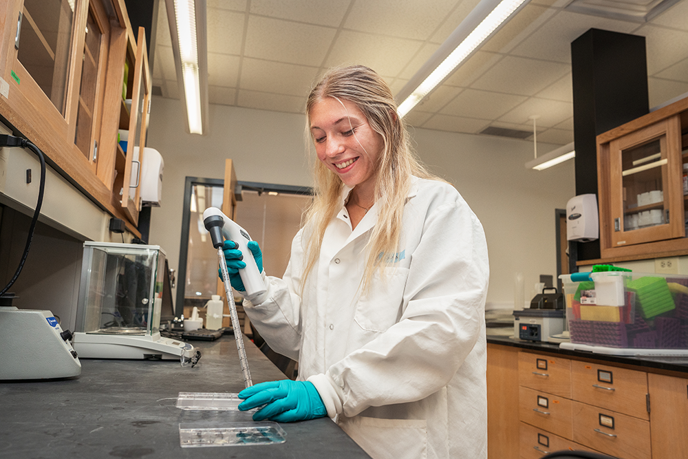 Undergraduate student works in lab